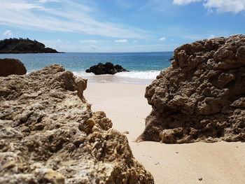 Rocks on beach against sky