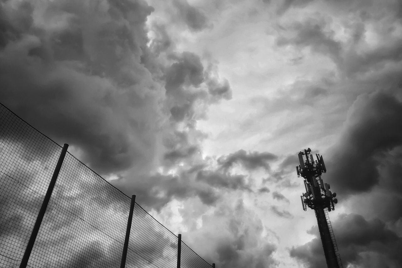cloud - sky, sky, low angle view, nature, no people, outdoors, day, overcast, architecture, built structure, silhouette, technology, tall - high, fence, communication, building exterior, arts culture and entertainment, beauty in nature, floodlight