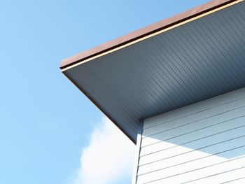 Low angle view of modern building against blue sky