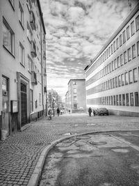 Street amidst buildings against sky in city