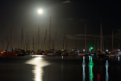Sailboats in marina at night