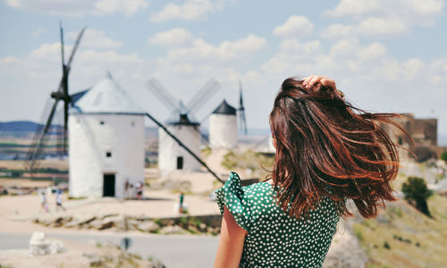 Rear view of woman standing against sky