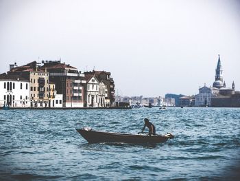 Boat sailing in sea against clear sky