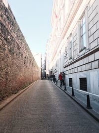 People in front of building against sky