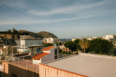 The view over city with old buildings and roofs and seaview , architecture.