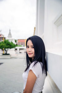 Portrait of a smiling young woman standing outdoors