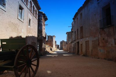 Street amidst buildings against sky in city