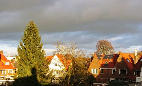 Low angle view of houses in town against sky