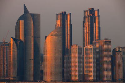 The sunset glow on the windows of the building creates a mysterious color.