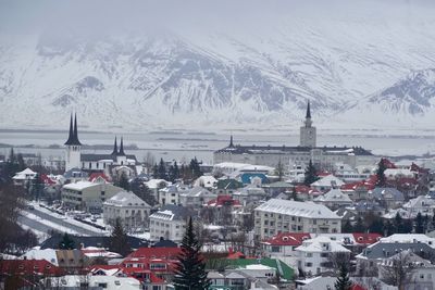 High angle view of snow covered buildings in city