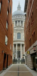 Street amidst buildings in city against sky