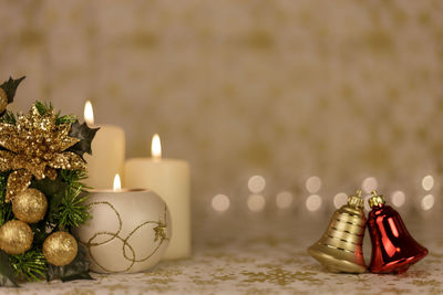 Close-up of christmas decorations with candles on table