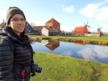 Portrait of smiling woman standing against built structure