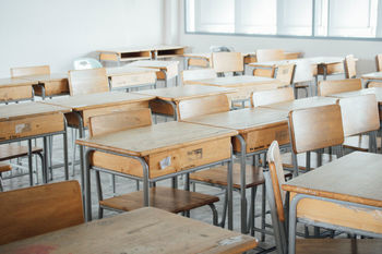 Empty chairs and tables in classroom