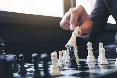 Midsection of man playing chess