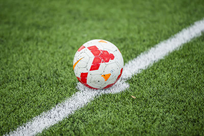 Close-up of soccer ball on field