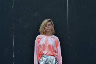 Woman standing against wall