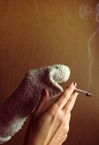 Sock puppet smoking a cigarette.