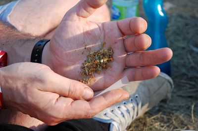 Midsection of man hands holding marijuana