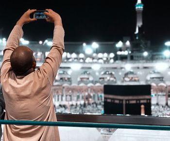 Rear view of man photographing