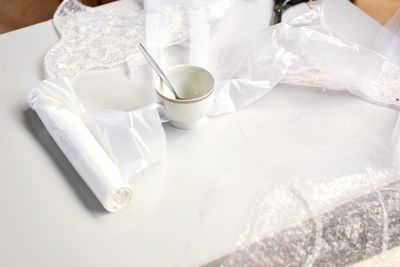 High angle view of coffee cup on white table