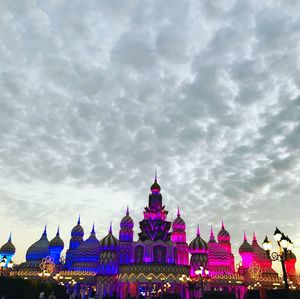 Low angle view of buildings against cloudy sky