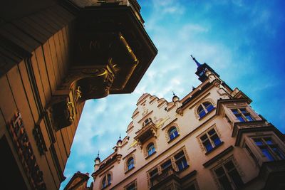 Low angle view of buildings against cloudy sky