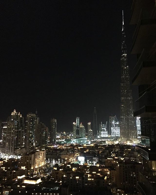 city, building exterior, architecture, cityscape, built structure, skyscraper, night, illuminated, tall - high, modern, office building, tower, crowded, urban skyline, financial district, city life, high angle view, clear sky, capital cities, development