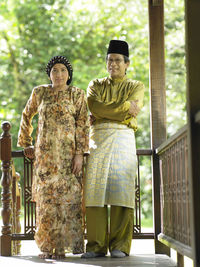 Couple standing in gazebo at yard