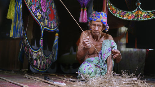 Man working in traditional clothing