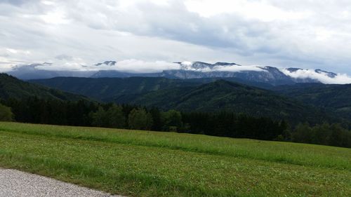 Scenic view of mountains against cloudy sky