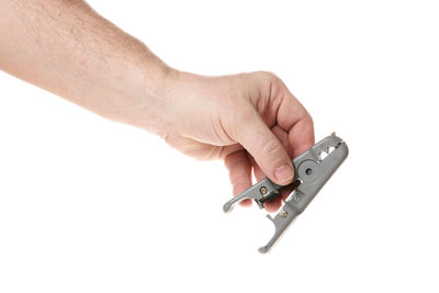 Close-up of hand holding toy against white background