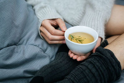 Midsection of woman holding coffee