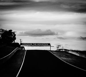 Road sign against sky