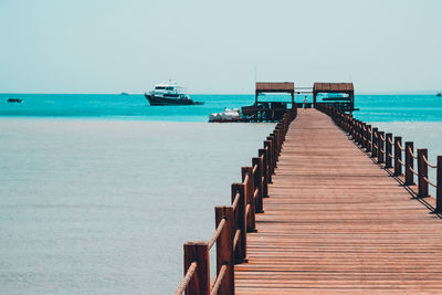 Pier over sea against clear sky