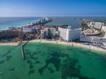 High angle view of swimming pool by buildings against sky