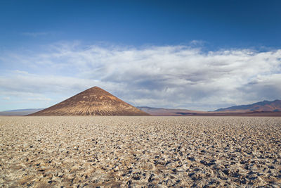 View of desert against cloudy sky