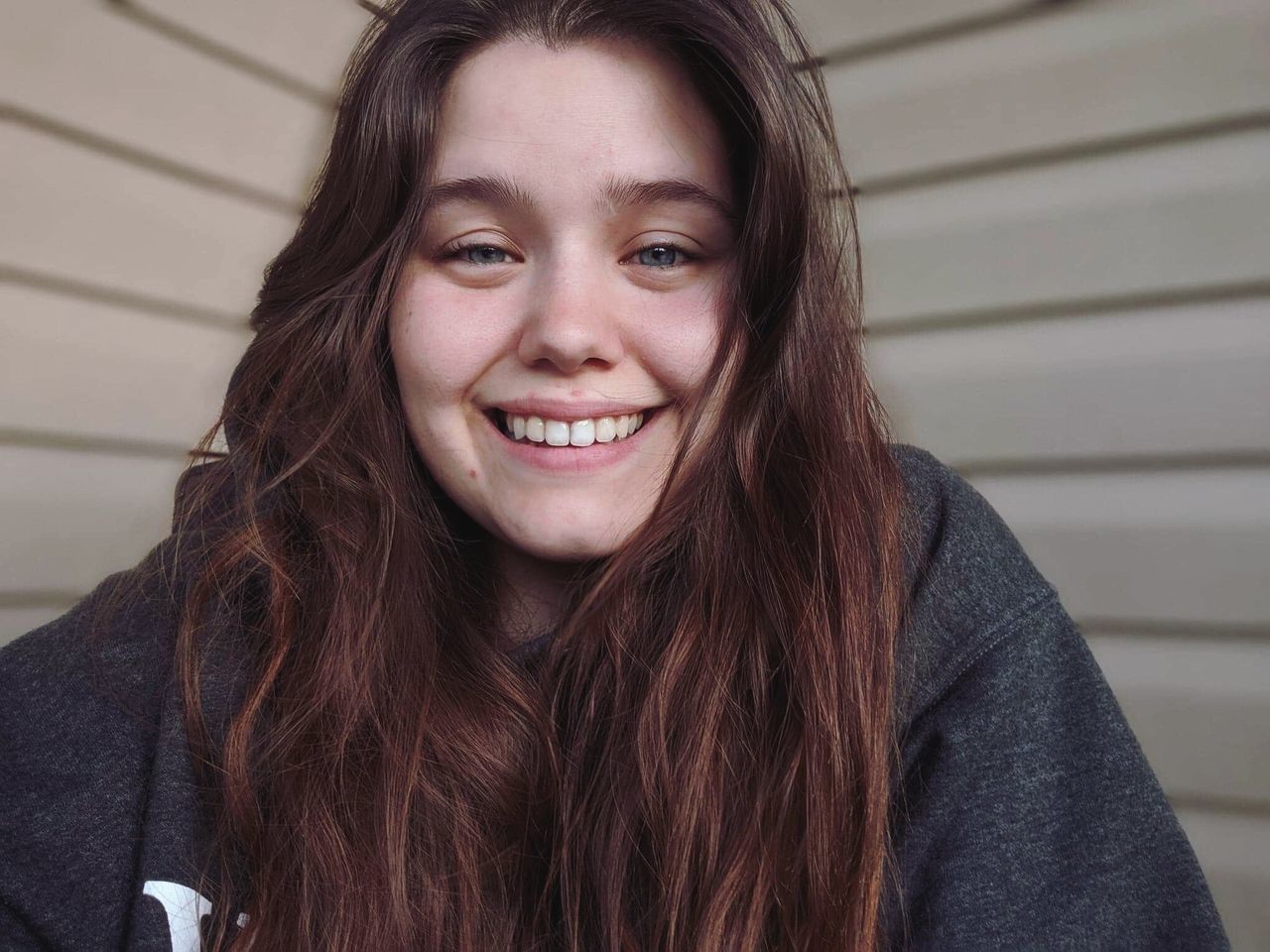 portrait, smiling, headshot, long hair, looking at camera, happiness, one person, hair, front view, young adult, brown hair, hairstyle, young women, real people, beautiful woman, beauty, toothy smile, teeth, emotion, teenager