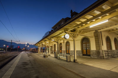 Illuminated empty railroad station at dusk