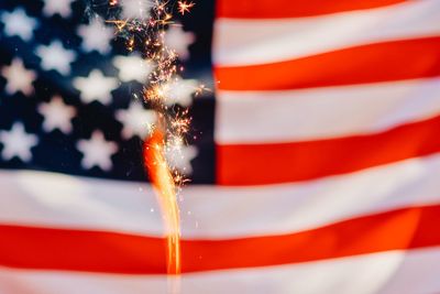 Full frame shot of american flag with sparkler