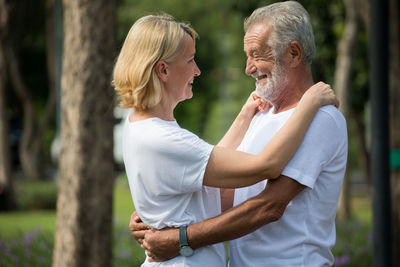 Senior man embracing woman