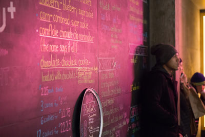 Close-up of woman sitting on wall