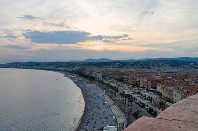 High angle view of buildings by sea against sky