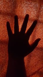 Shadow of person hand on silhouette floor