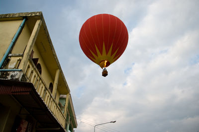 Low angle view of hot air balloon flying against sky