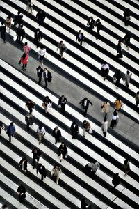 High angle view of people crossing road in city