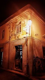 Low angle view of illuminated building at night