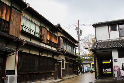 Street amidst buildings in city against sky