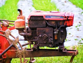 Close-up of old machine part on field