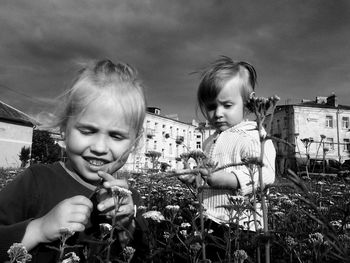 Portrait of smiling girl standing against sky